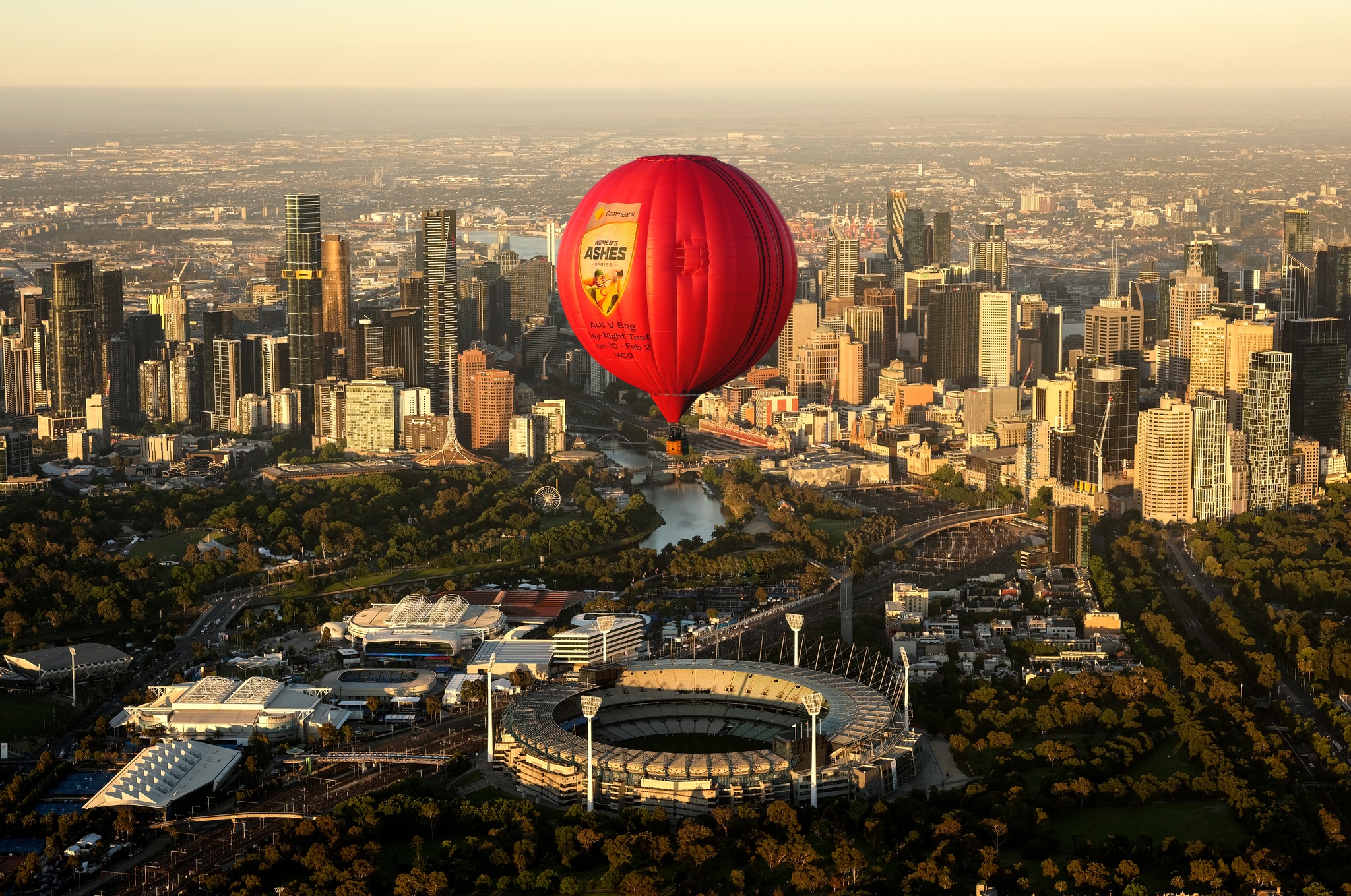 A hot air balloon flying over the MCG