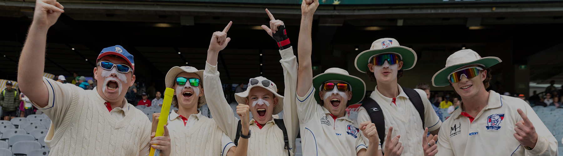 A group of men in cricket whites celebrating at the Boxing Day Test