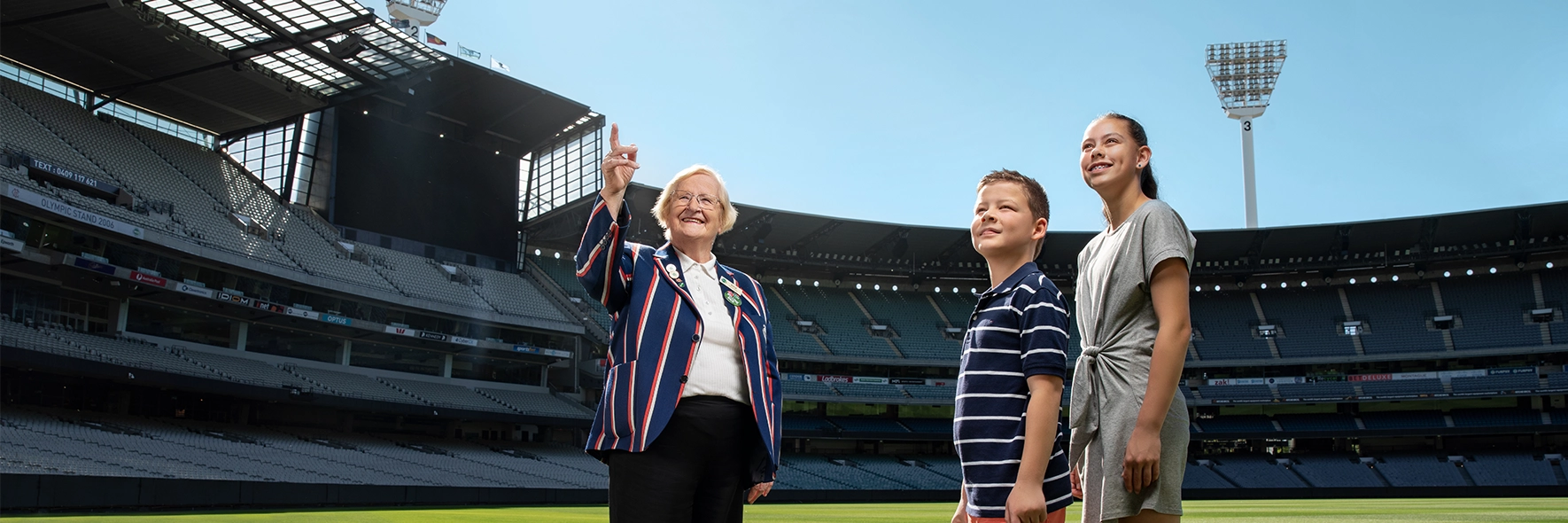 MCG Premium Access Tour An MCG Tour Guide and two children on a Premium Access Tour