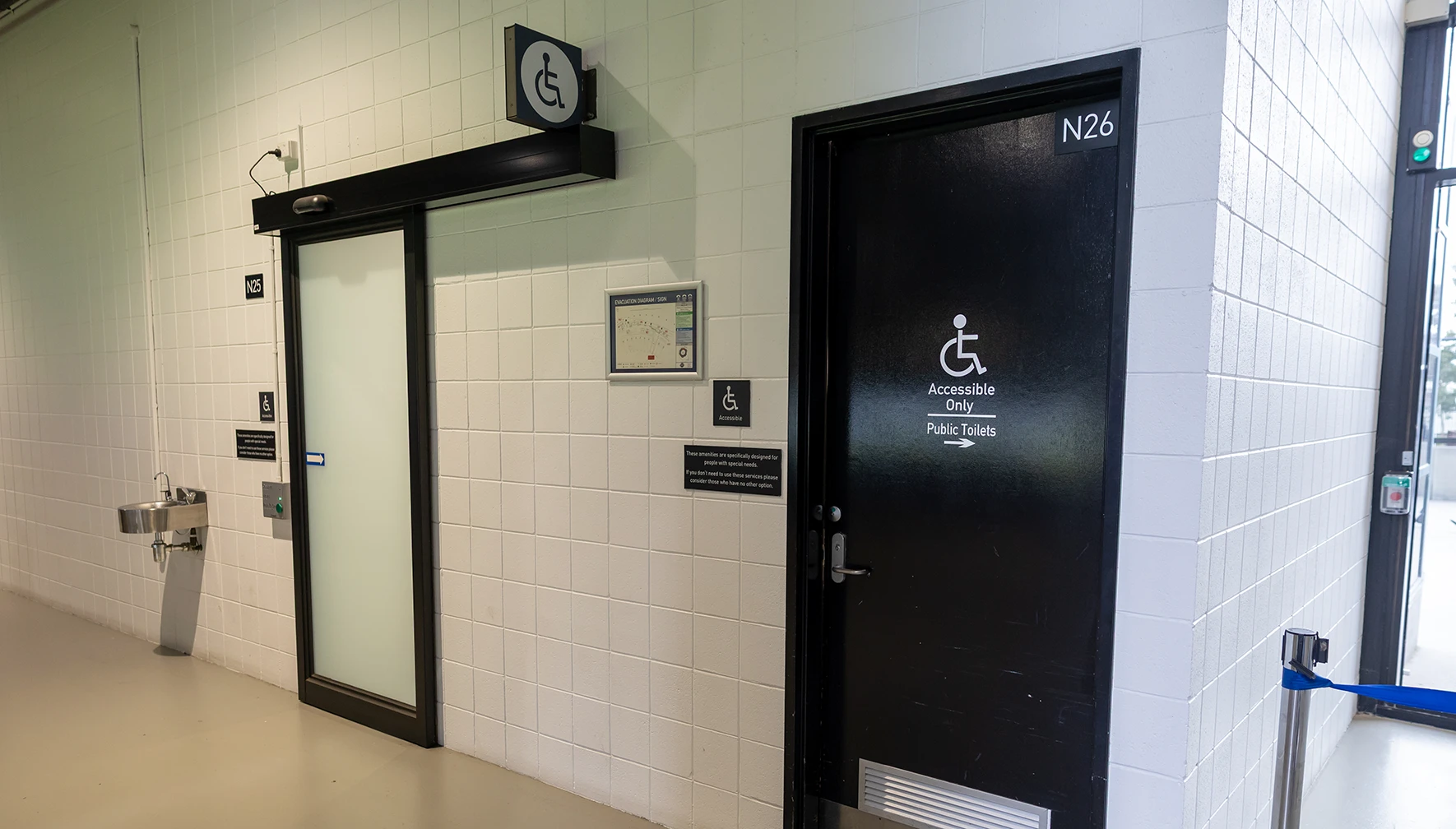 Two accessible bathrooms with wheelchair symbol of access signs