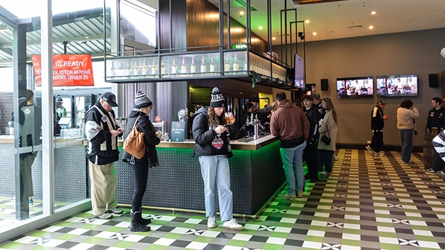Fans stand at the indoor bar at The Outer Bar at the MCG Fans stand at the indoor bar at The Outer Bar at the MCG