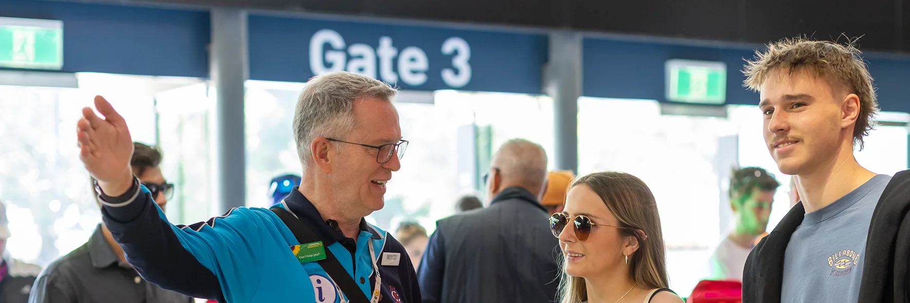 Stadium staff member points out directions to patrons