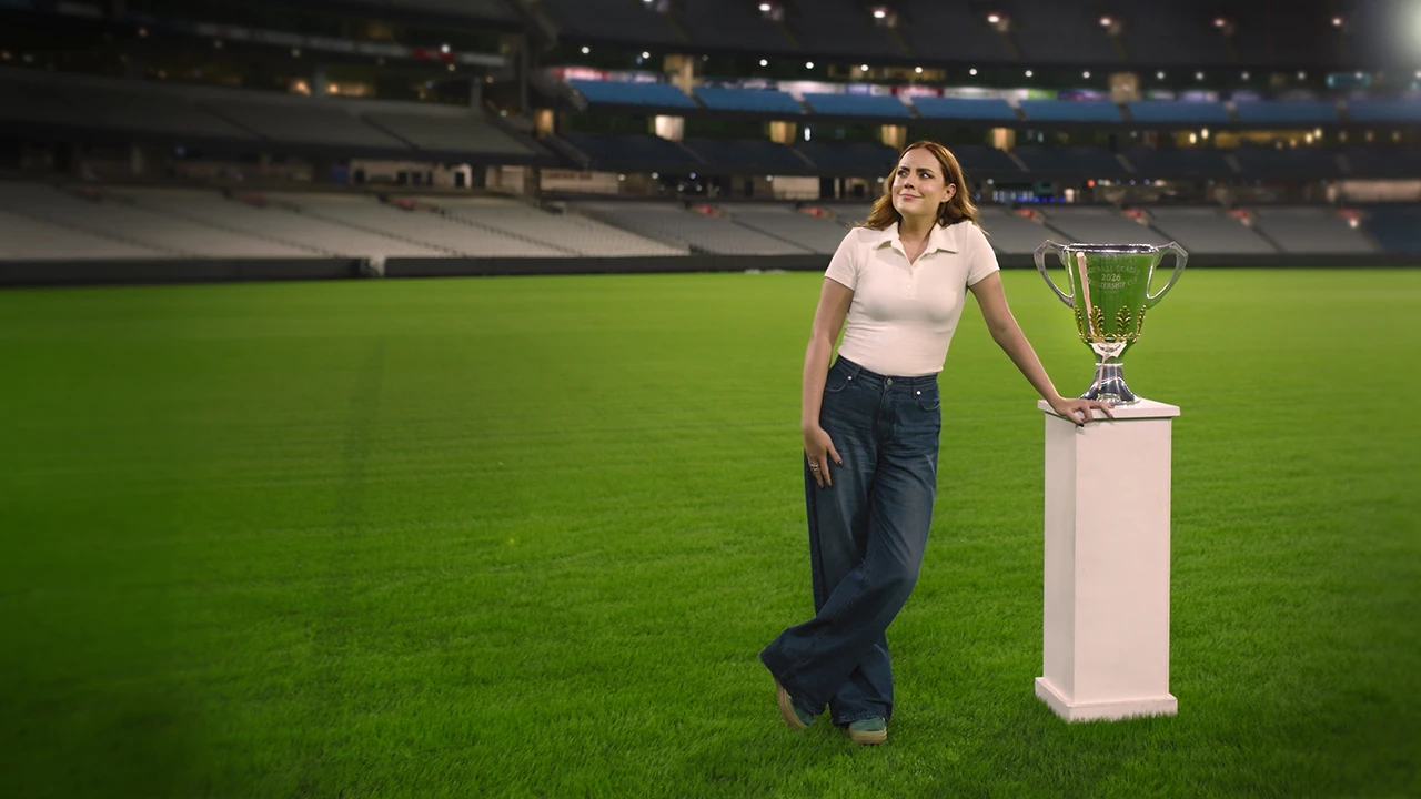 No Place Like Home Georgie Tunny stands on the MCG next to the 2026 AFL Premiership Cup