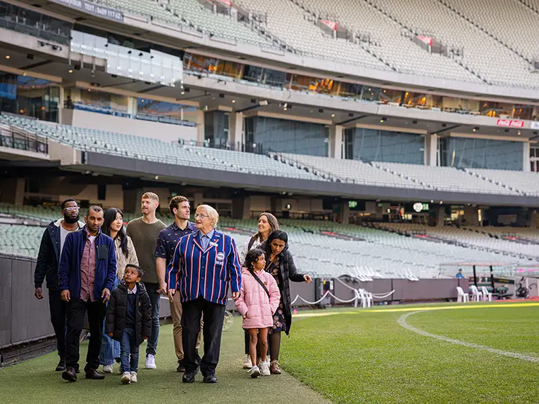 Tour guide leading a group on the MCG boundary line