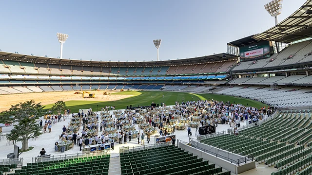 Outdoor function on MCG arena surrounded by stadium seats