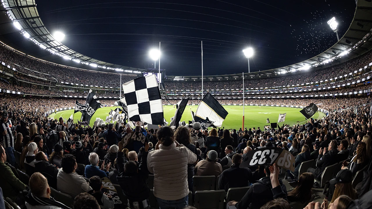 Collingwood FC at the MCG Collingwood fans waving flags from the stands at the MCG