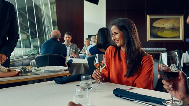 Waiter serving a smiling guest at fine dining restaurant